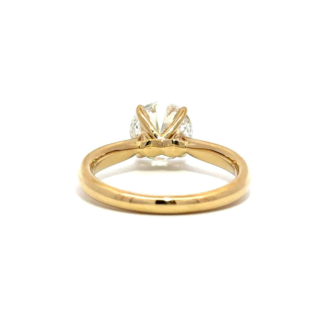 Back view of gold engagement ring with a round-cut center diamond.