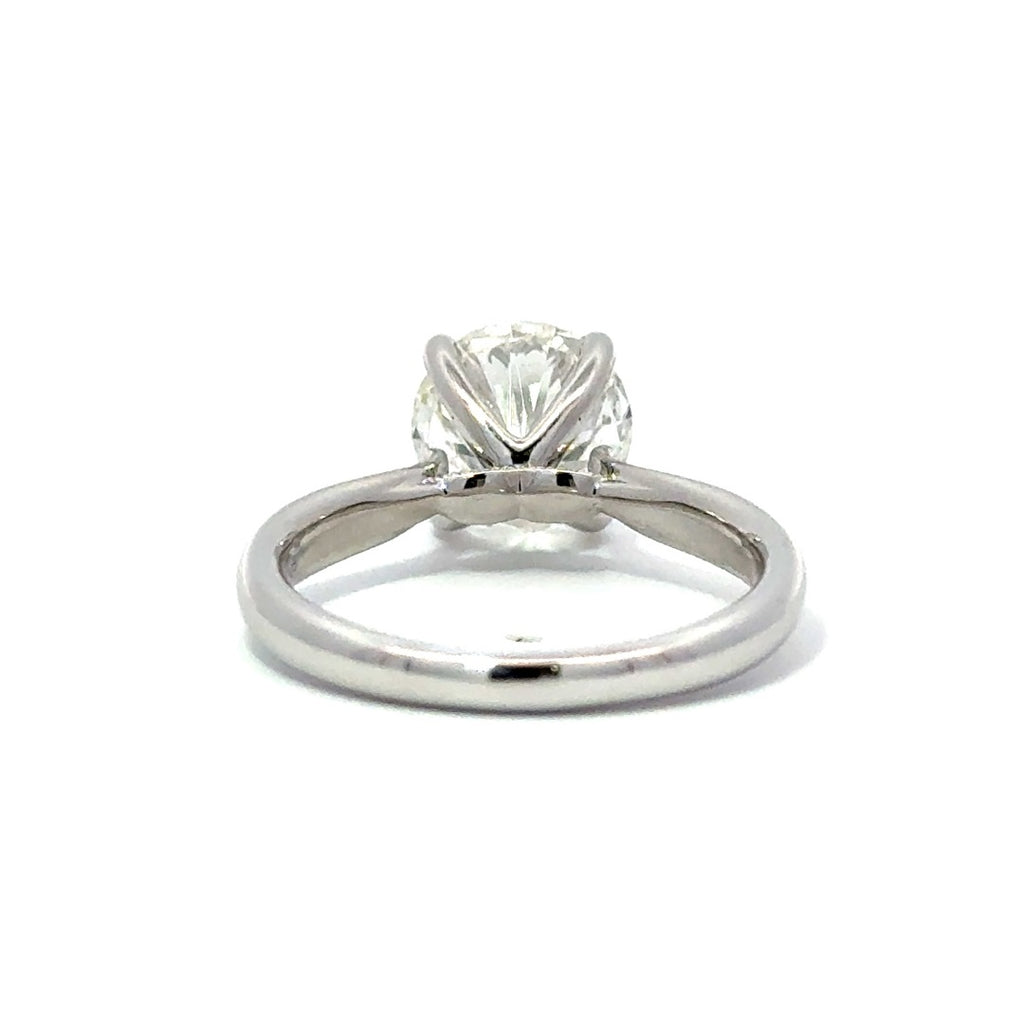 Back view of silver engagement ring with a round-cut center diamond.