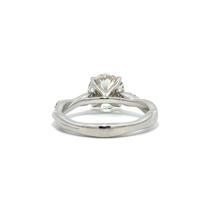 Back view of silver engagement ring with a round-cut center diamond.