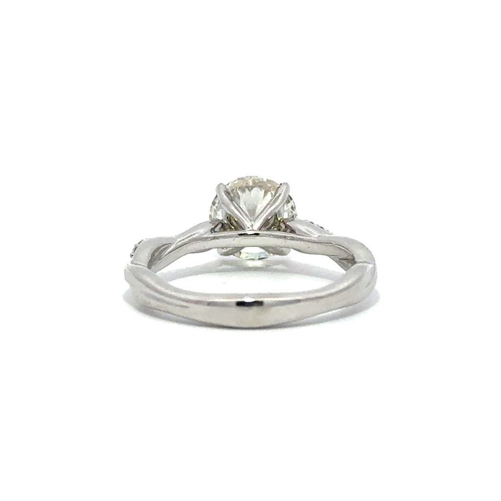 Back view of silver engagement ring with a round-cut center diamond.