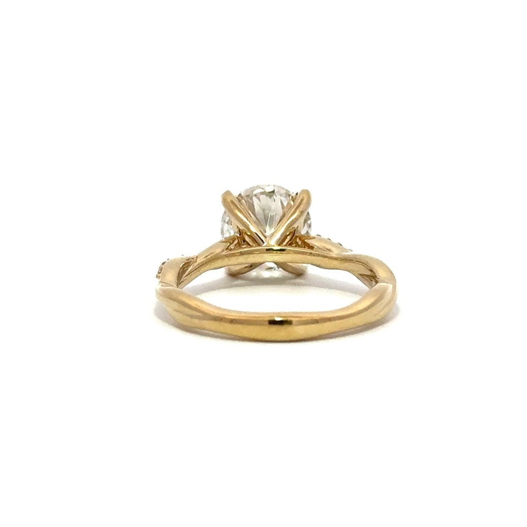 Back view of gold engagement ring with a round-cut center diamond.