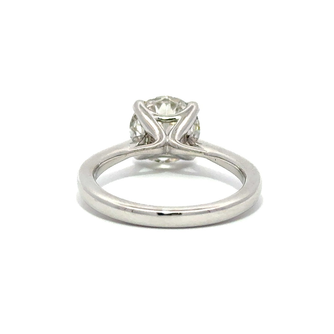 Back view of silver engagement ring with a round-cut center diamond.