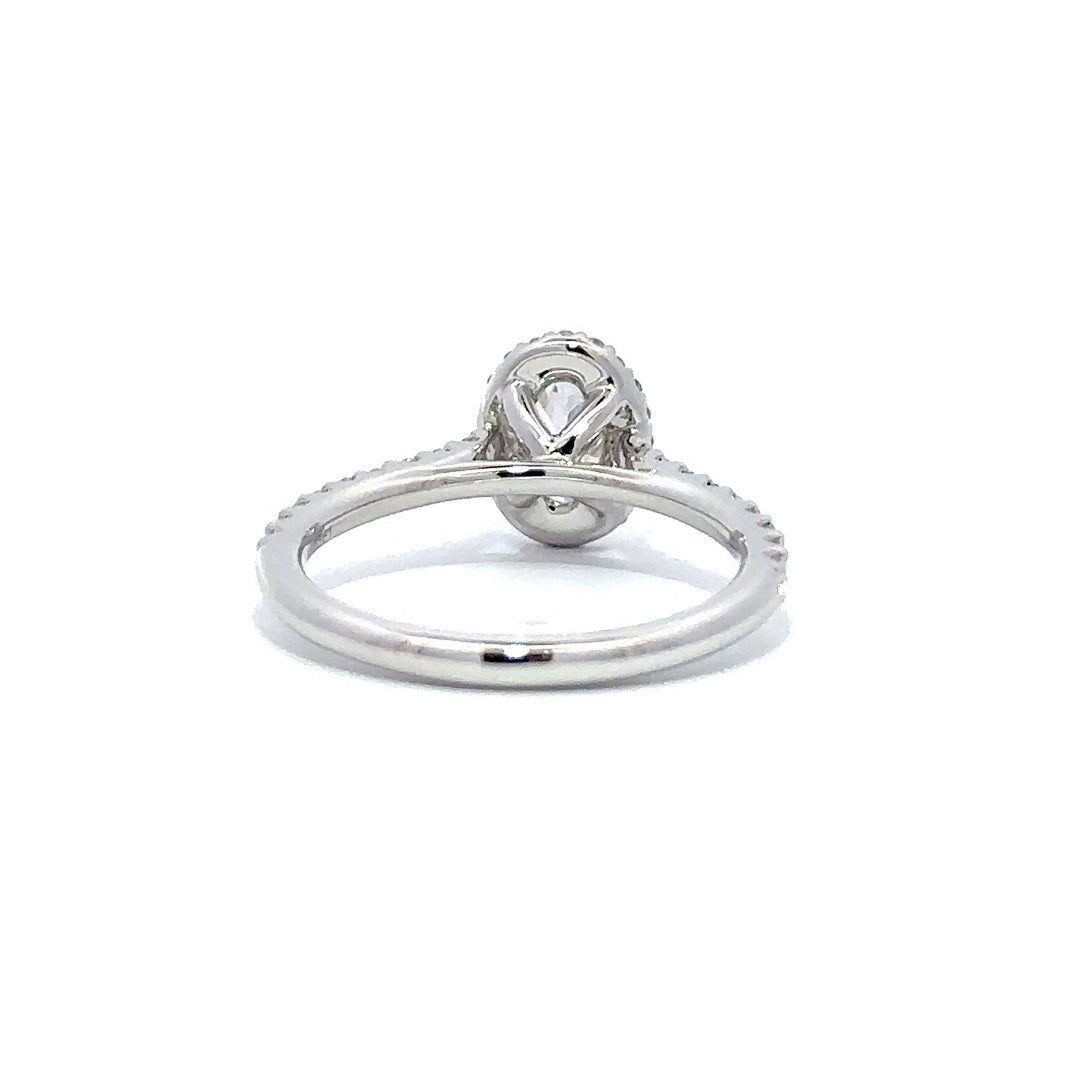 Back view of a silver engagement ring with a round-cut center diamond.