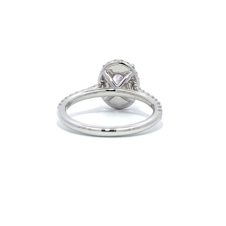 Back view of a silver engagement ring with a round-cut center diamond.