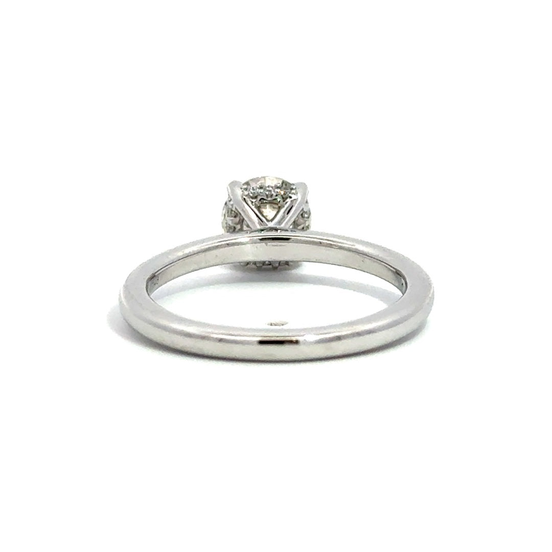 Back view of silver engagement ring with a round-cut center diamond.