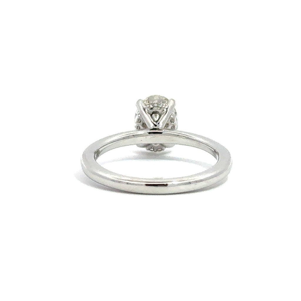 Back view of silver engagement ring with a oval-cut center diamond.