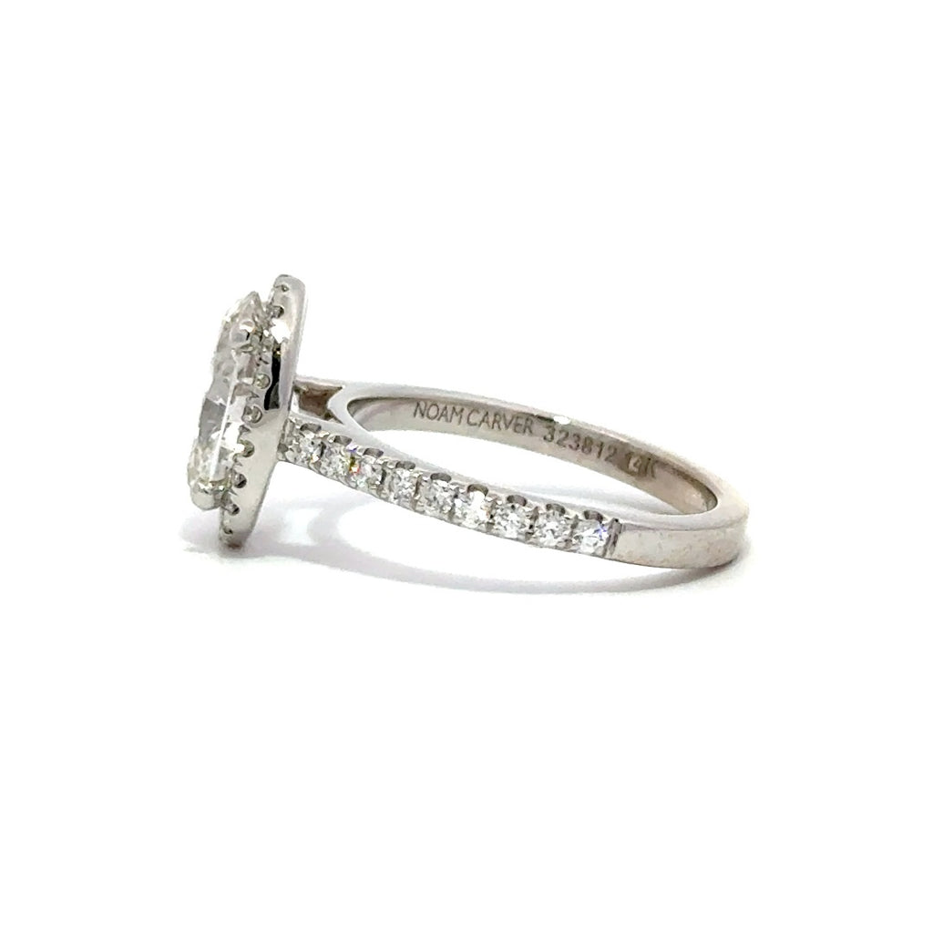 Silver ring with an oval-cut diamond center stone surrounded by a diamond halo and a diamond-studded band, on a white background.