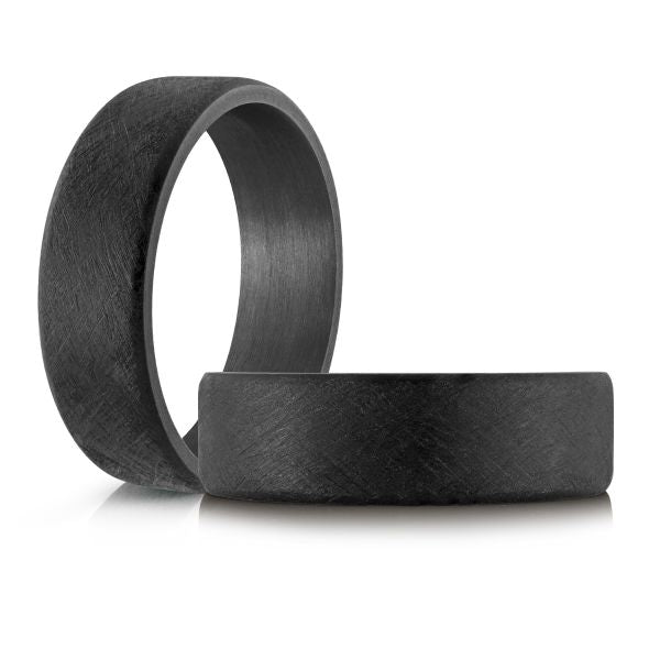 Black carbon fiber wedding band on a white background.