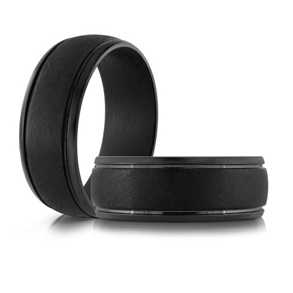 Black carbon fiber wedding band on a white background.