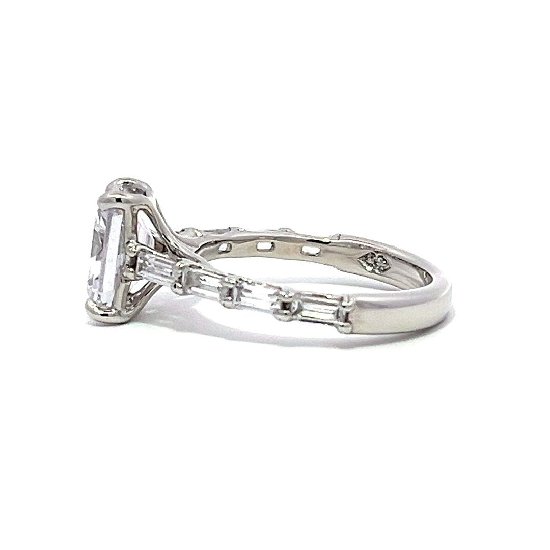 White gold oval diamond engagement ring with a diamond band on a white background.