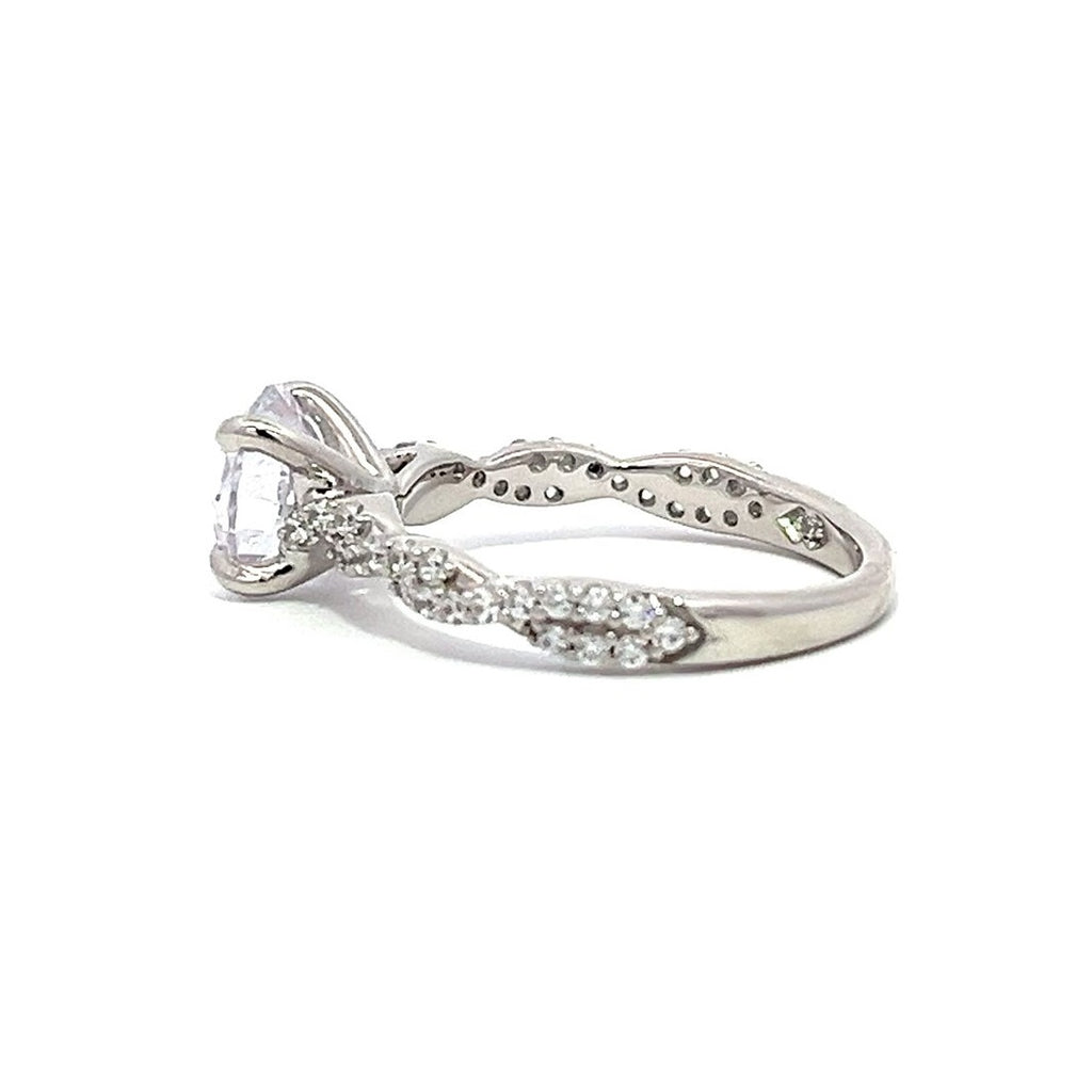 White gold diamond engagement ring with a twisted band on a white background.