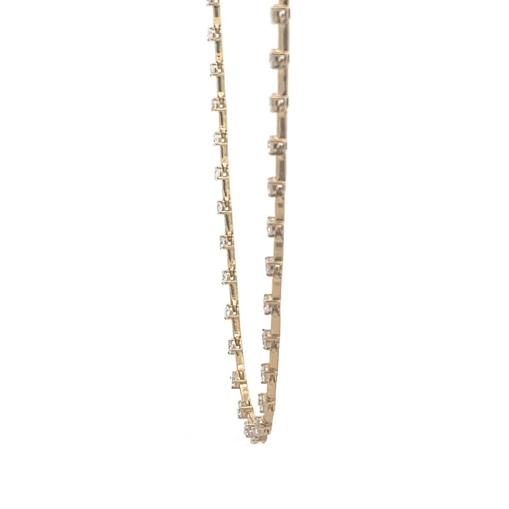 Yellow gold necklace with a row of round diamonds on a white background.