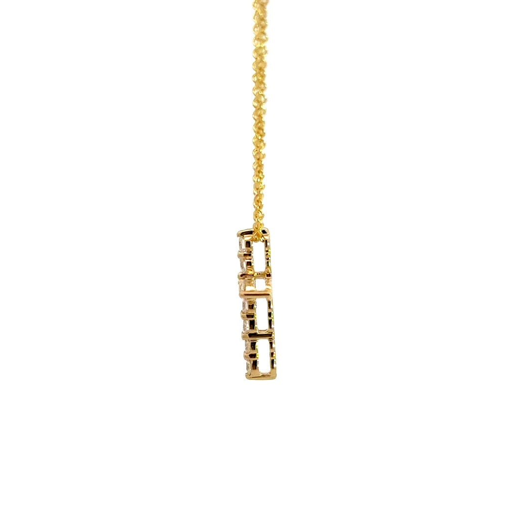 Yellow gold diamond cross necklace on a white background