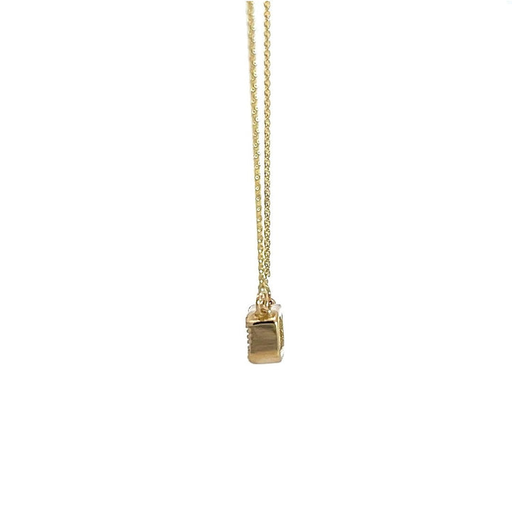 Yellow gold necklace with an emerald-cut diamond pendant on a white background.