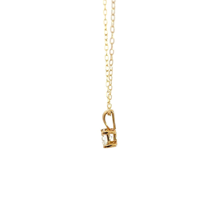 Yellow gold diamond solitaire necklace on a white background.