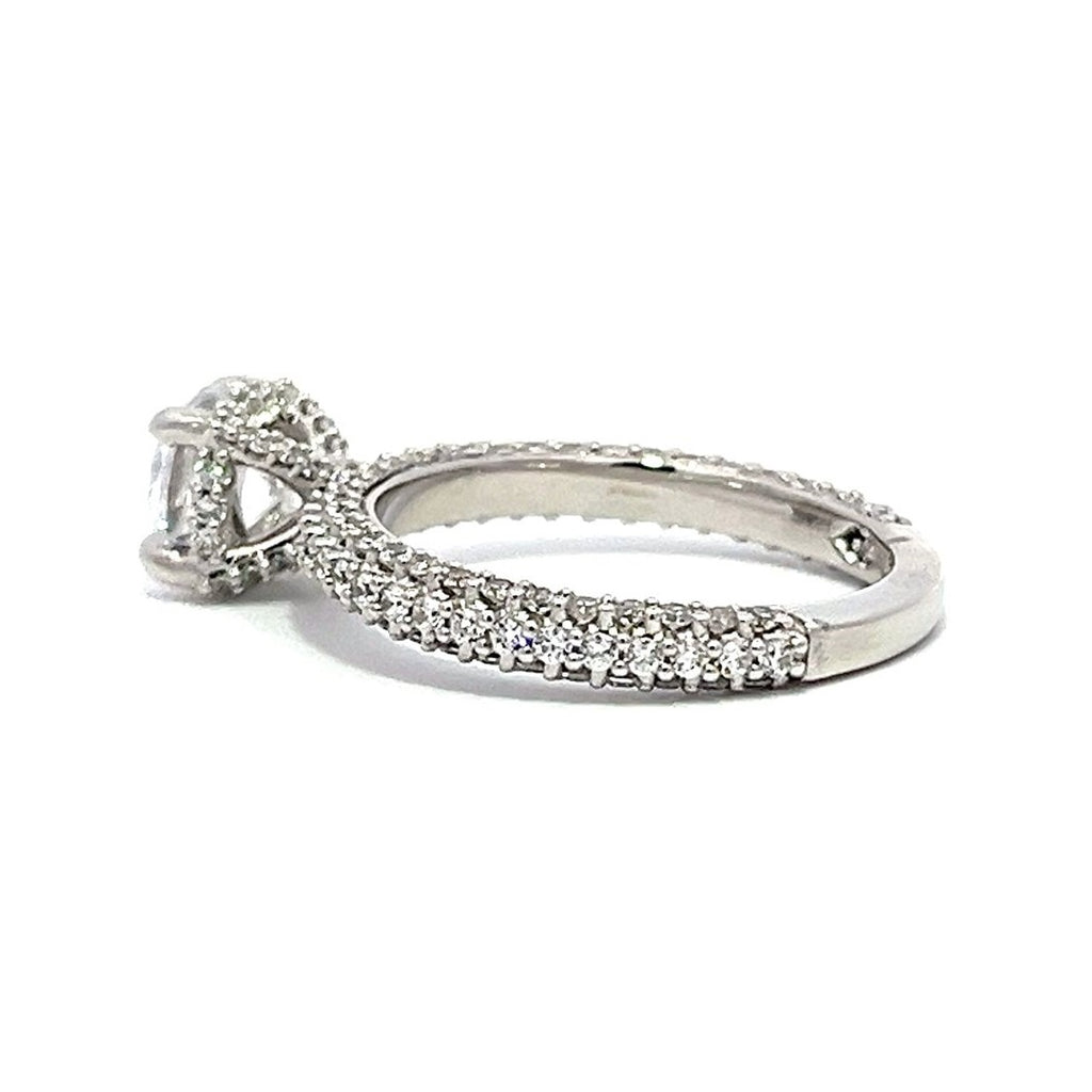 White gold round-shaped diamond engagement ring with a diamond band on a white background.