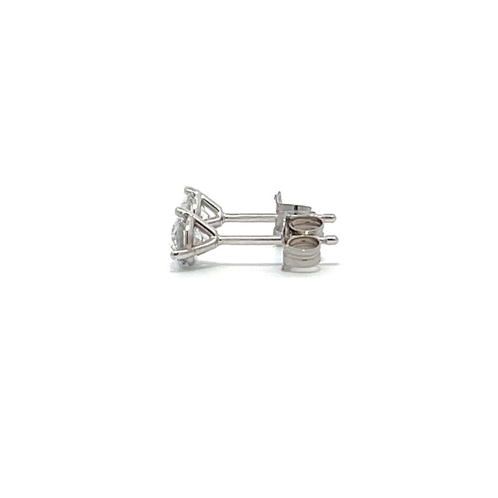 Pair of white gold stud earrings with a triangular setting of diamonds on a white background.