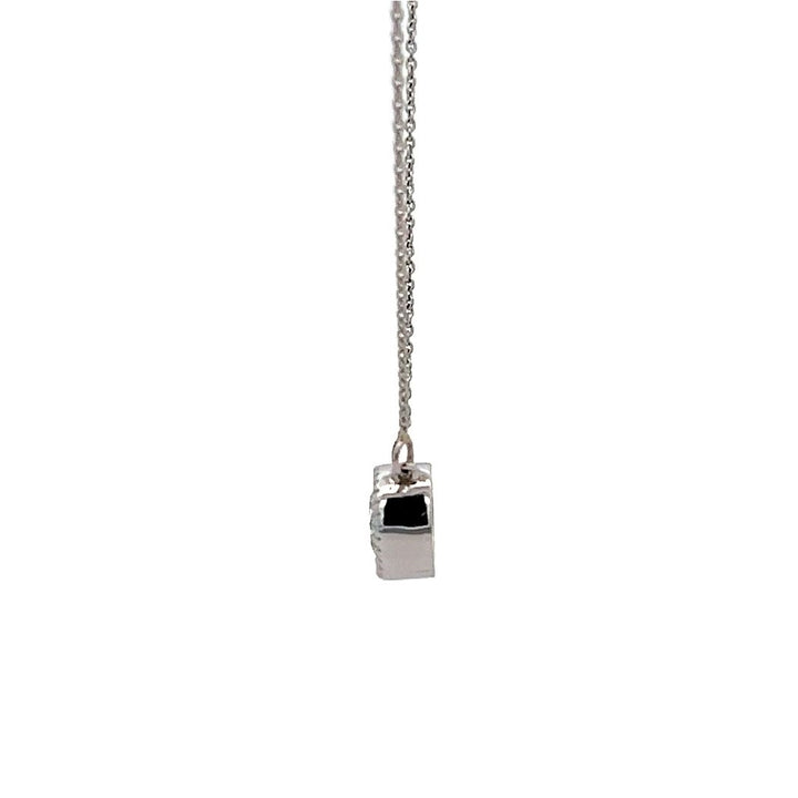 White gold necklace with a round diamond solitaire pendant on a white background.