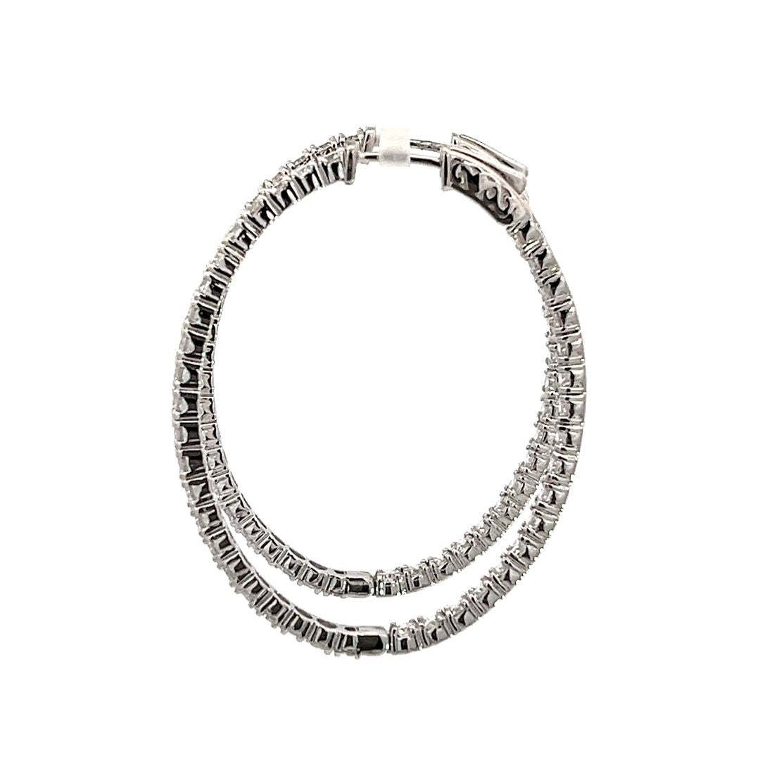 White gold diamond hoop earrings on a white background.