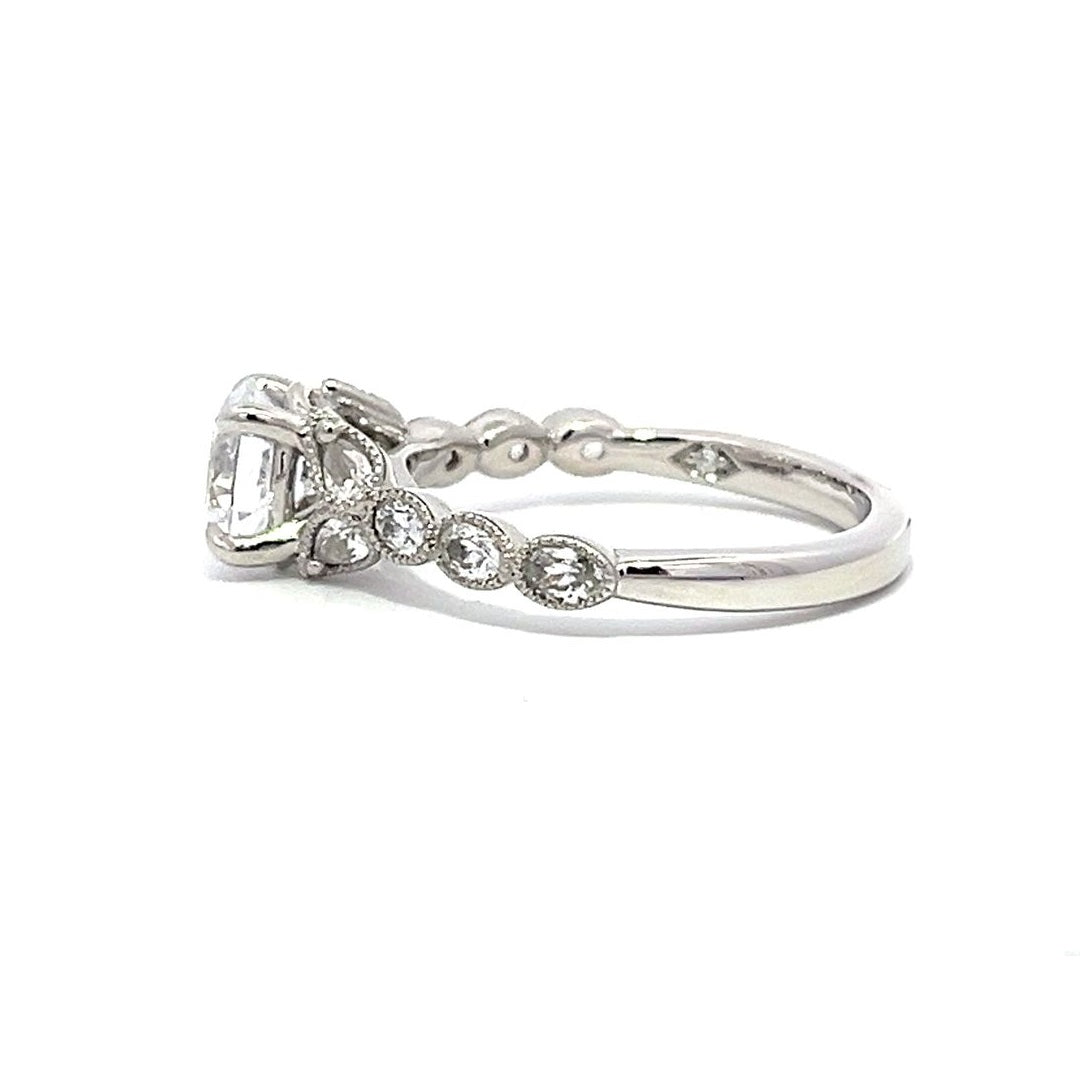 White gold diamond engagement ring with a diamond band on a white background