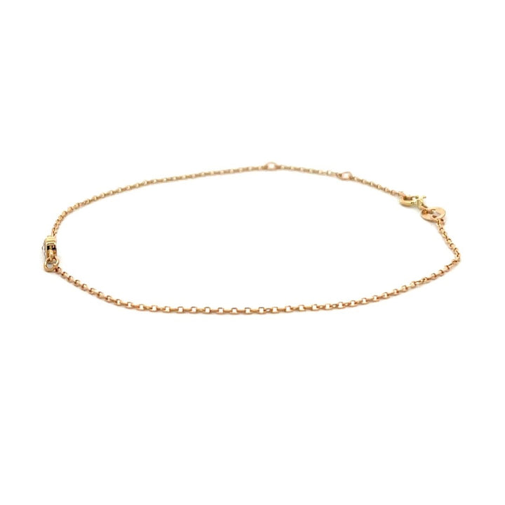 Yellow gold bracelet with a single diamond on a white background.