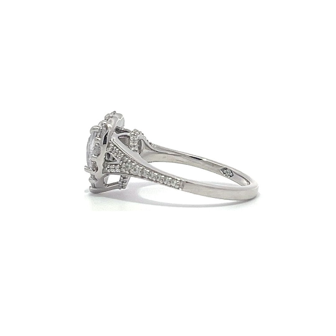 Silver heart-shaped diamond engagement ring with a halo setting and split shank on a white background.