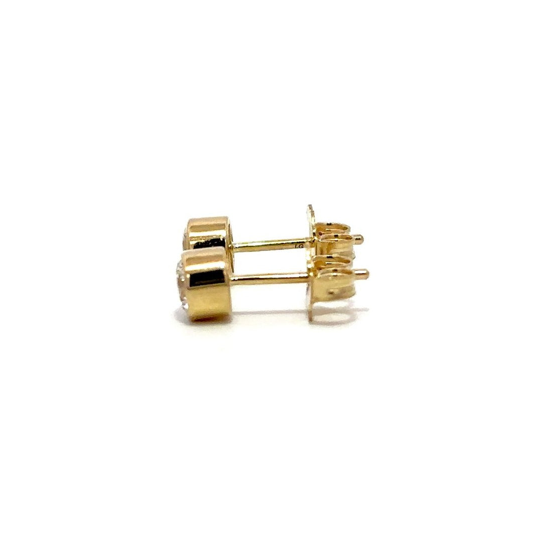 Yellow gold diamond stud earrings on a white background