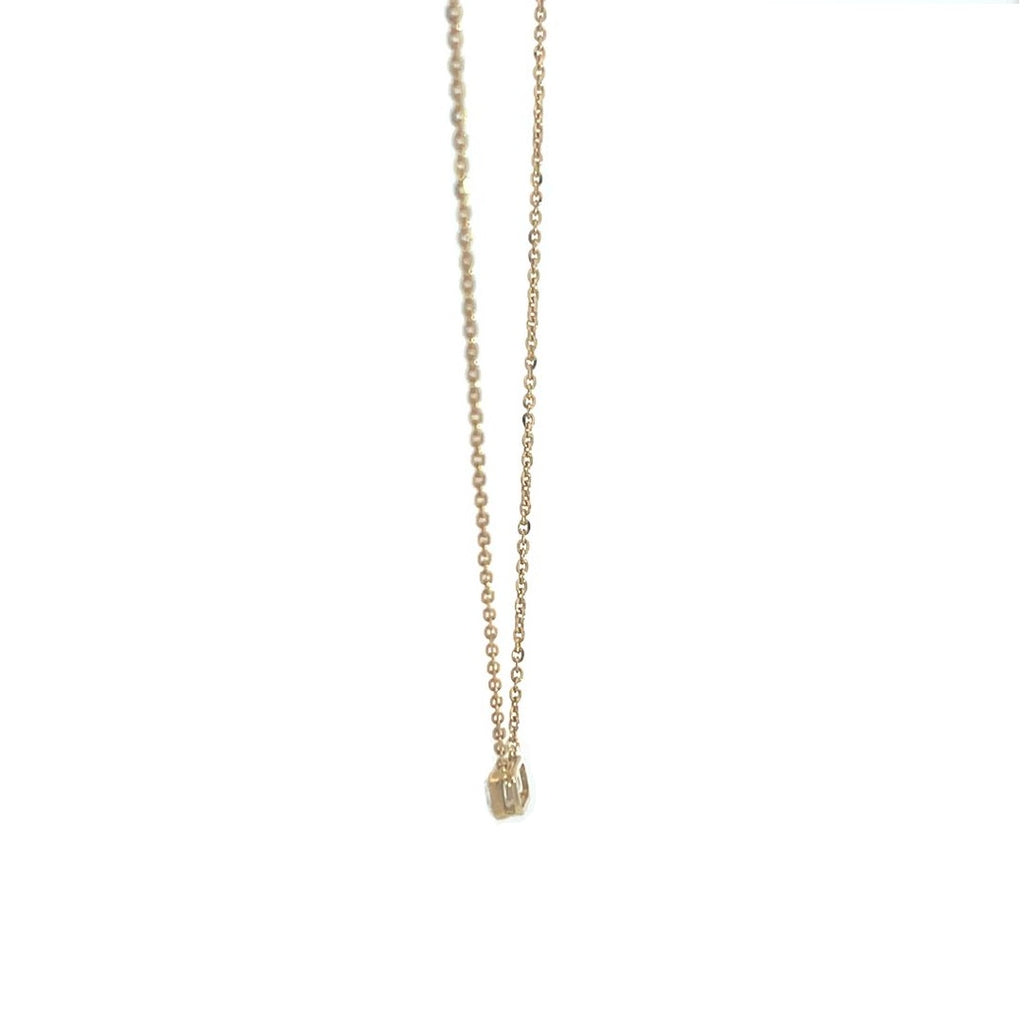 Yellow gold necklace with an emerald-cut diamond pendant on a white background.