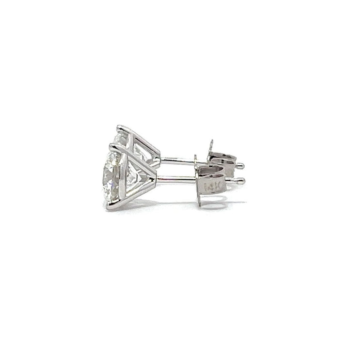 White gold stud earrings with round diamonds on a white background.