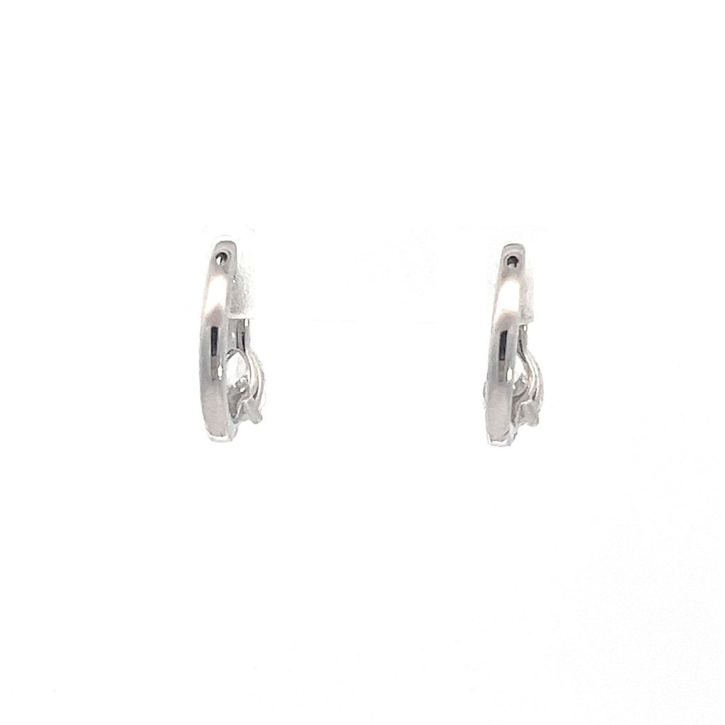 SIlver hoop earrings with round diamonds on a white background.