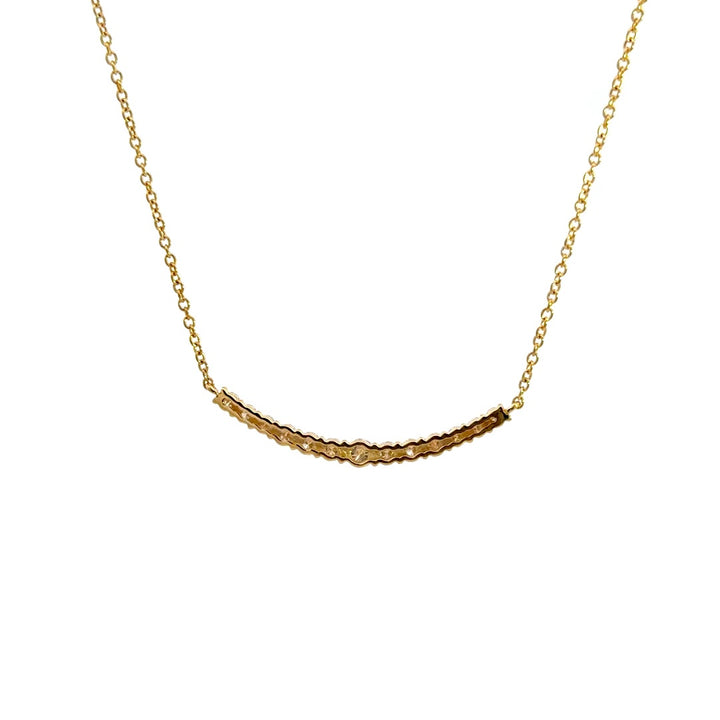 Yellow gold diamond necklace on a white background