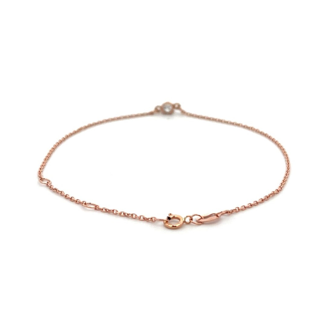 Rose gold bracelet with a single diamond on a white background.