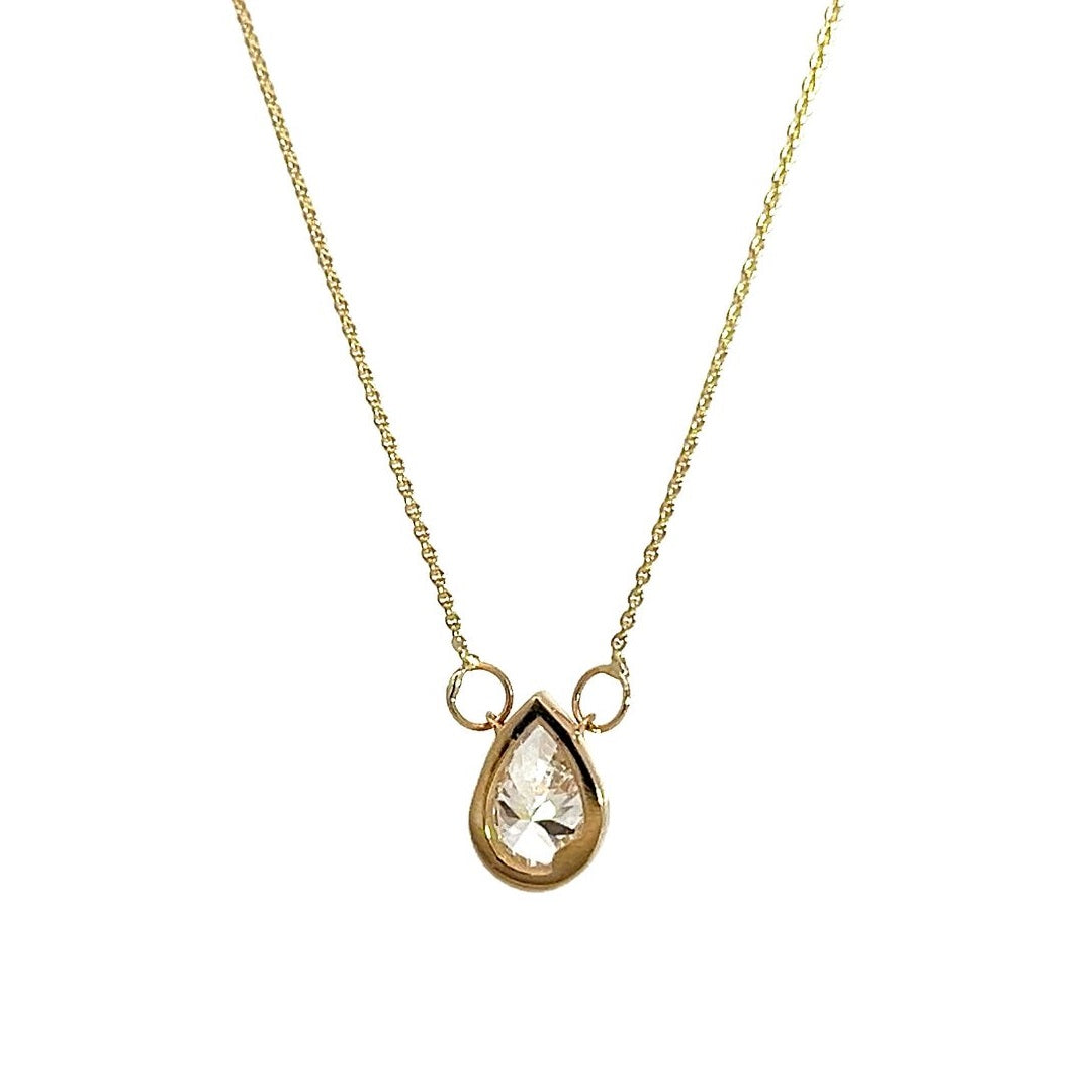  Yellow gold necklace with a pear-shaped diamond pendant on a white background.