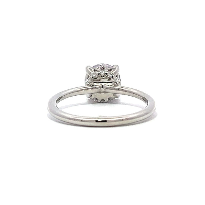 White gold diamond solitaire engagement ring on a white background.