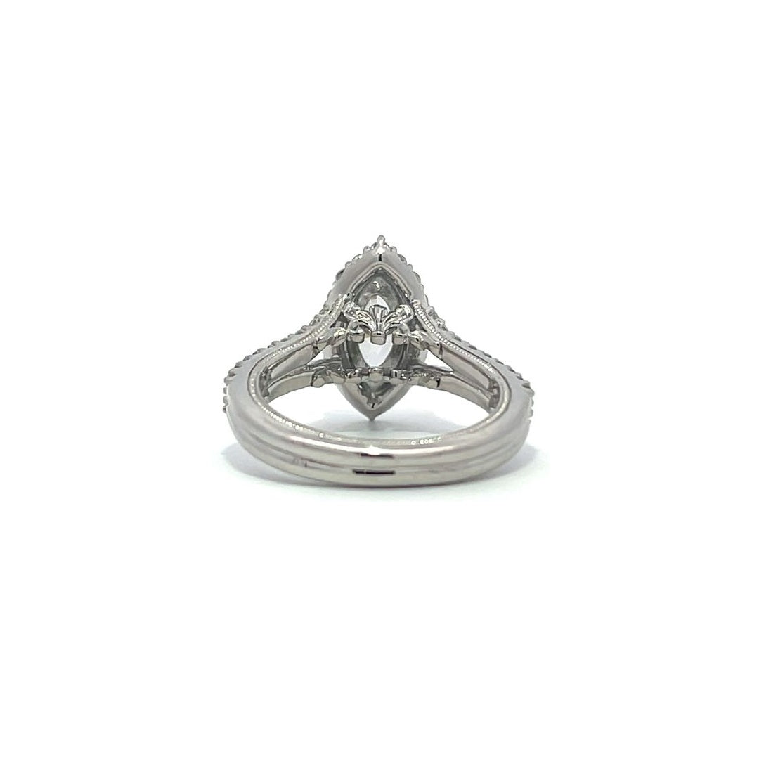 Silver pear-shaped diamond engagement ring with a halo setting and split shank on a white background.