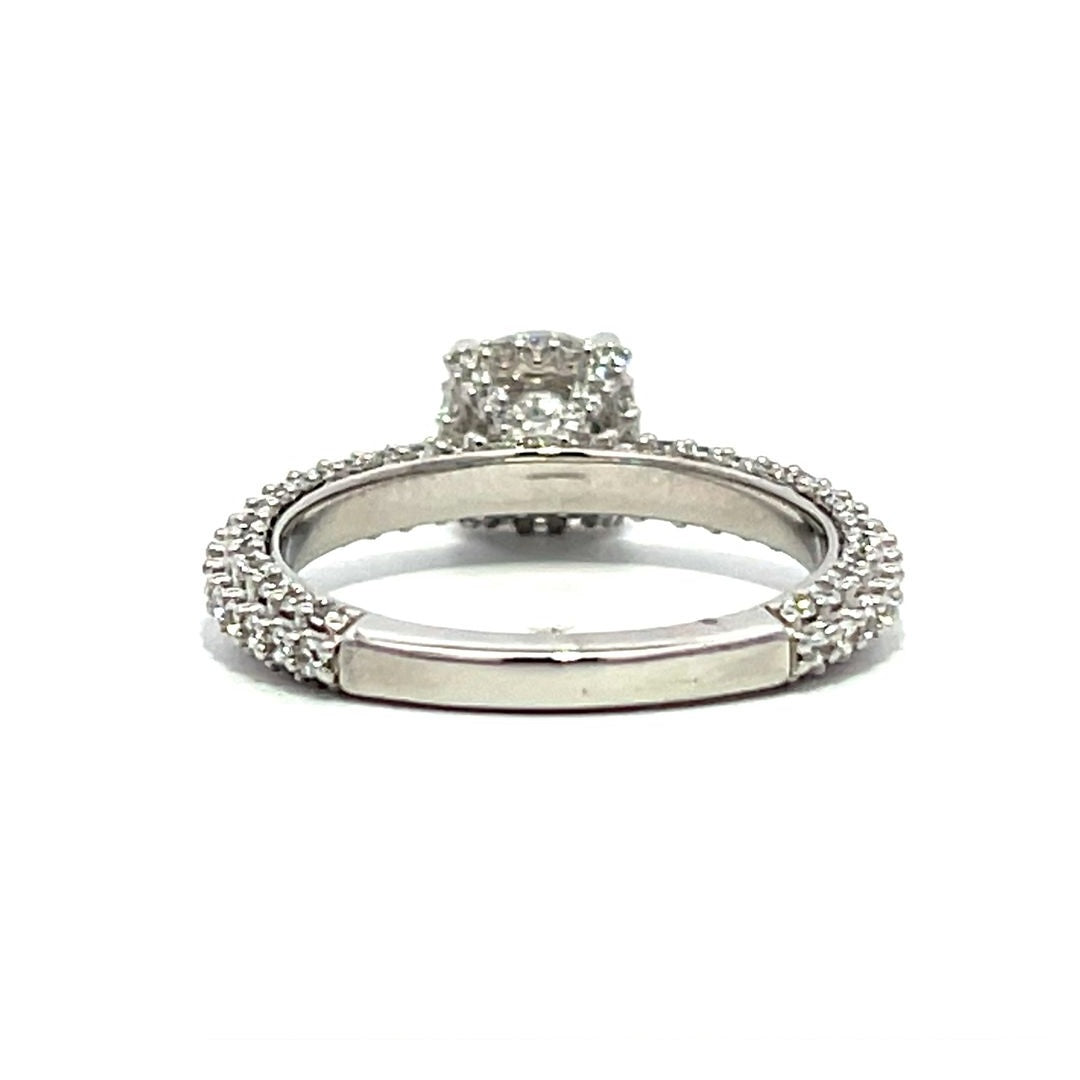 White gold round-shaped diamond engagement ring with a diamond band on a white background.