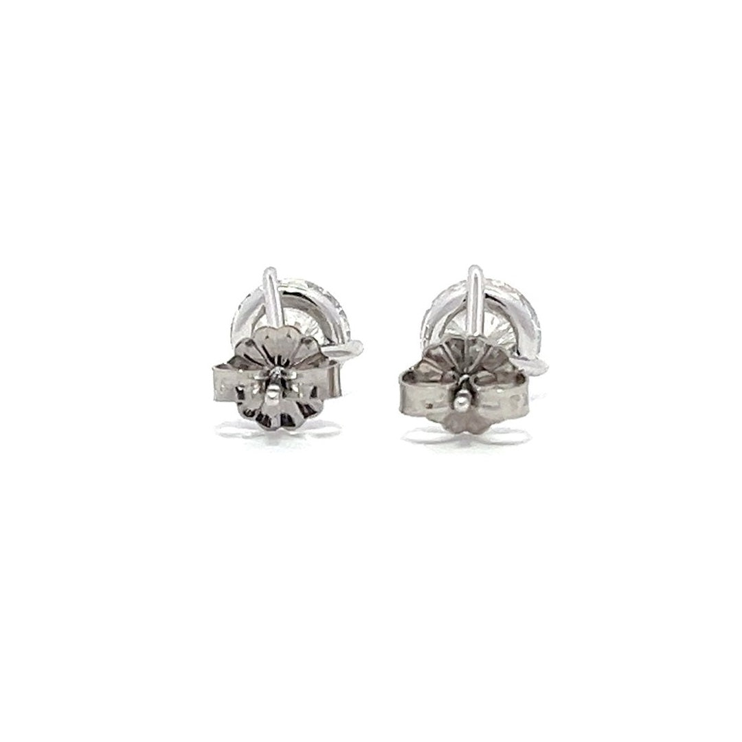 White gold stud earrings with round diamonds on a white background.