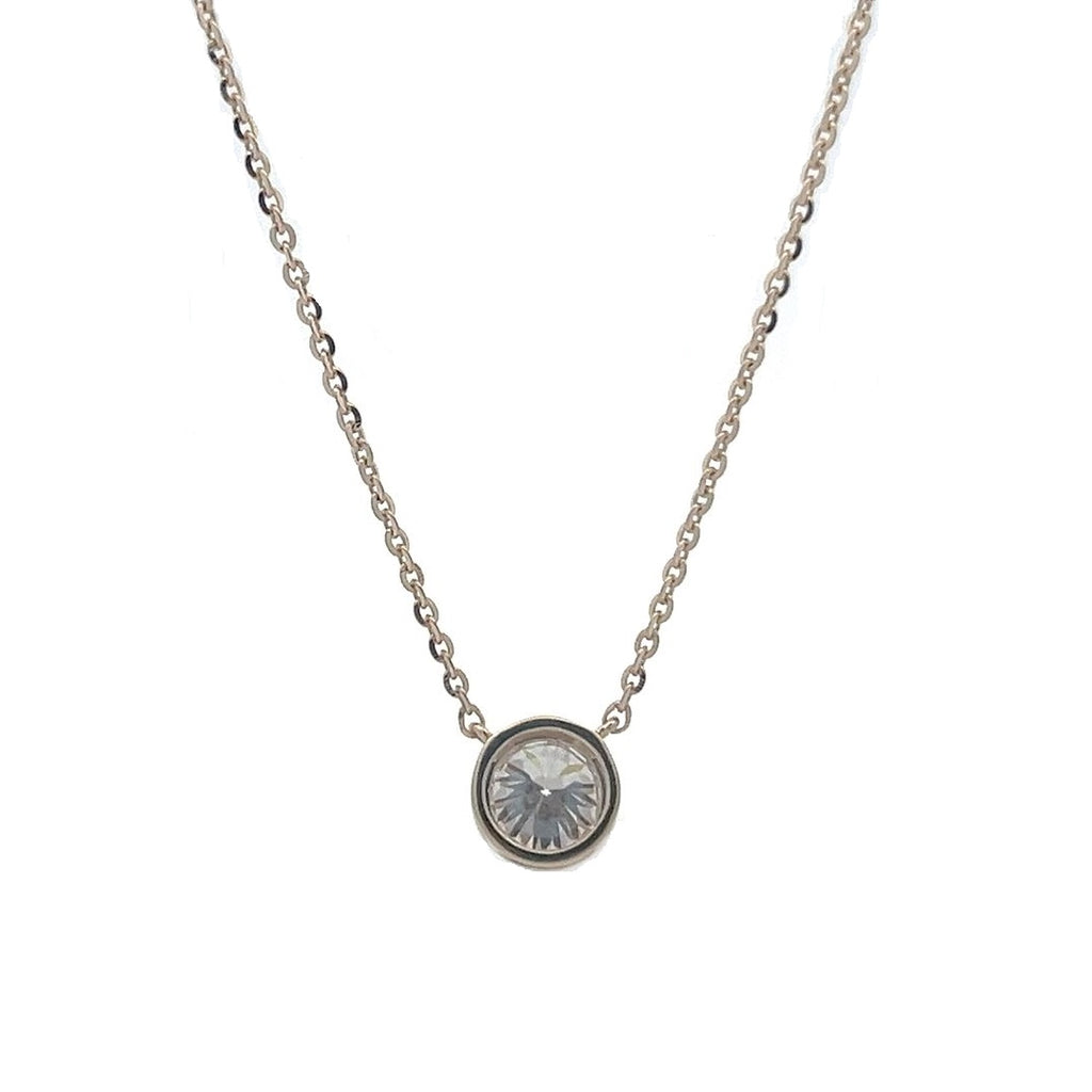 Yellow gold necklace with a round diamond solitaire pendant on a white background.