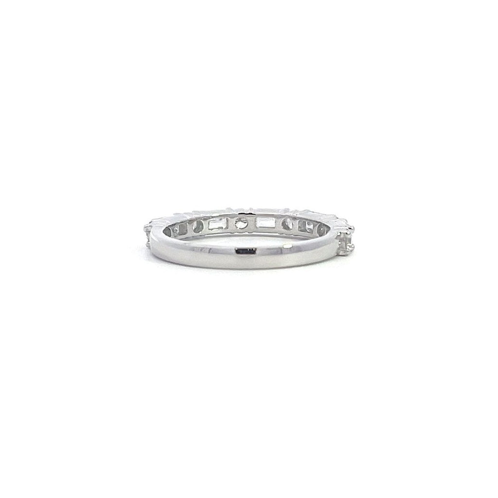 SIlver eternity band with alternating round and baguette-cut diamonds, on a white background.