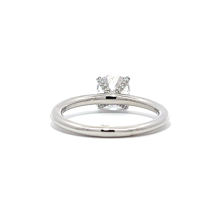 White gold diamond solitaire engagement ring on a white background.