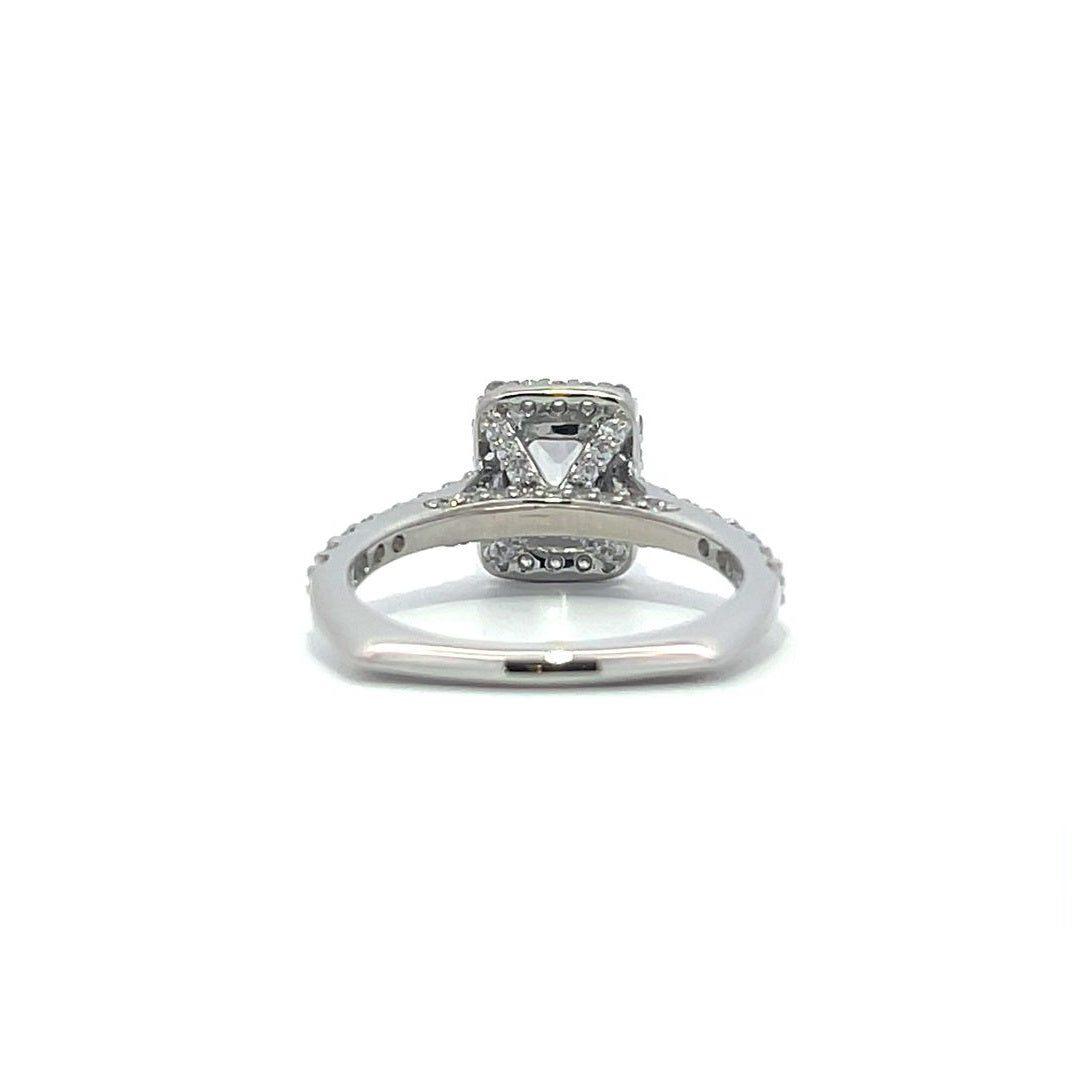 Silver emerald-cut engagement ring with a double halo setting on a white background