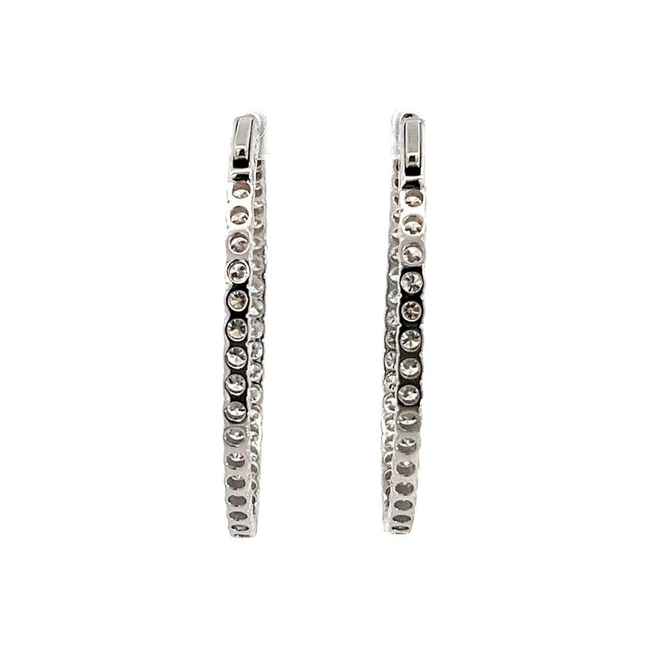 White gold diamond hoop earrings on a white background.