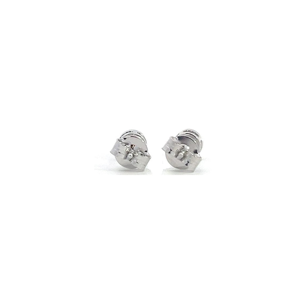 White gold stud earrings with round diamonds in  bezel setting on a white background.