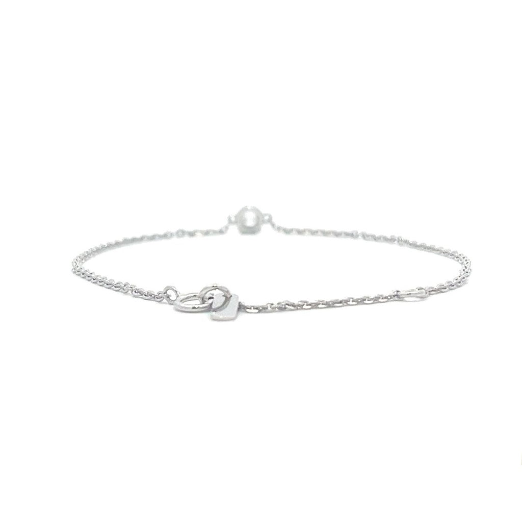 Silver bracelet with a single diamond pendant on a white background.