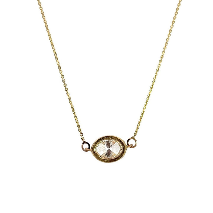 Yellow gold necklace with an oval-shaped diamond pendant on a white background.