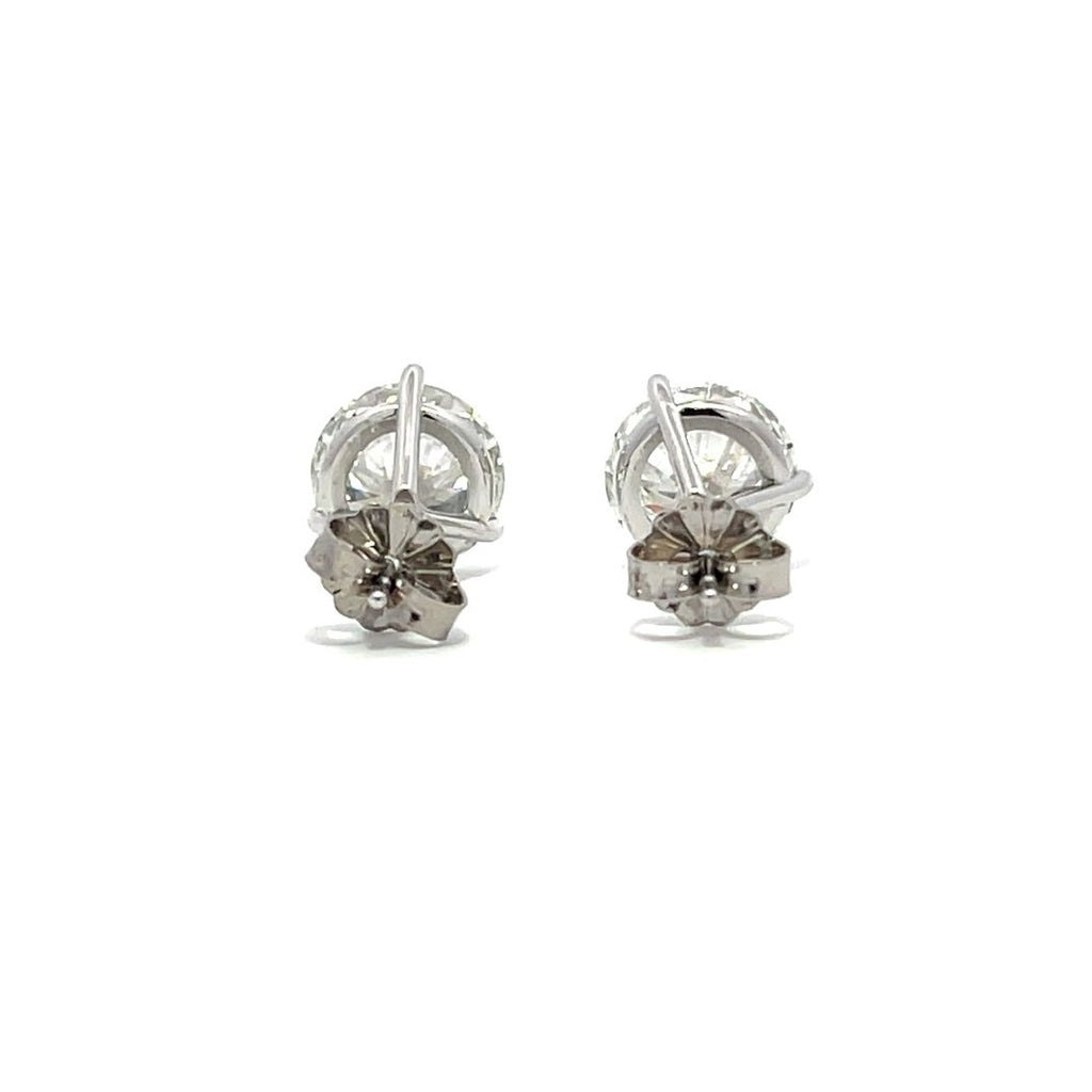 White gold stud earrings with round diamonds on a white background.