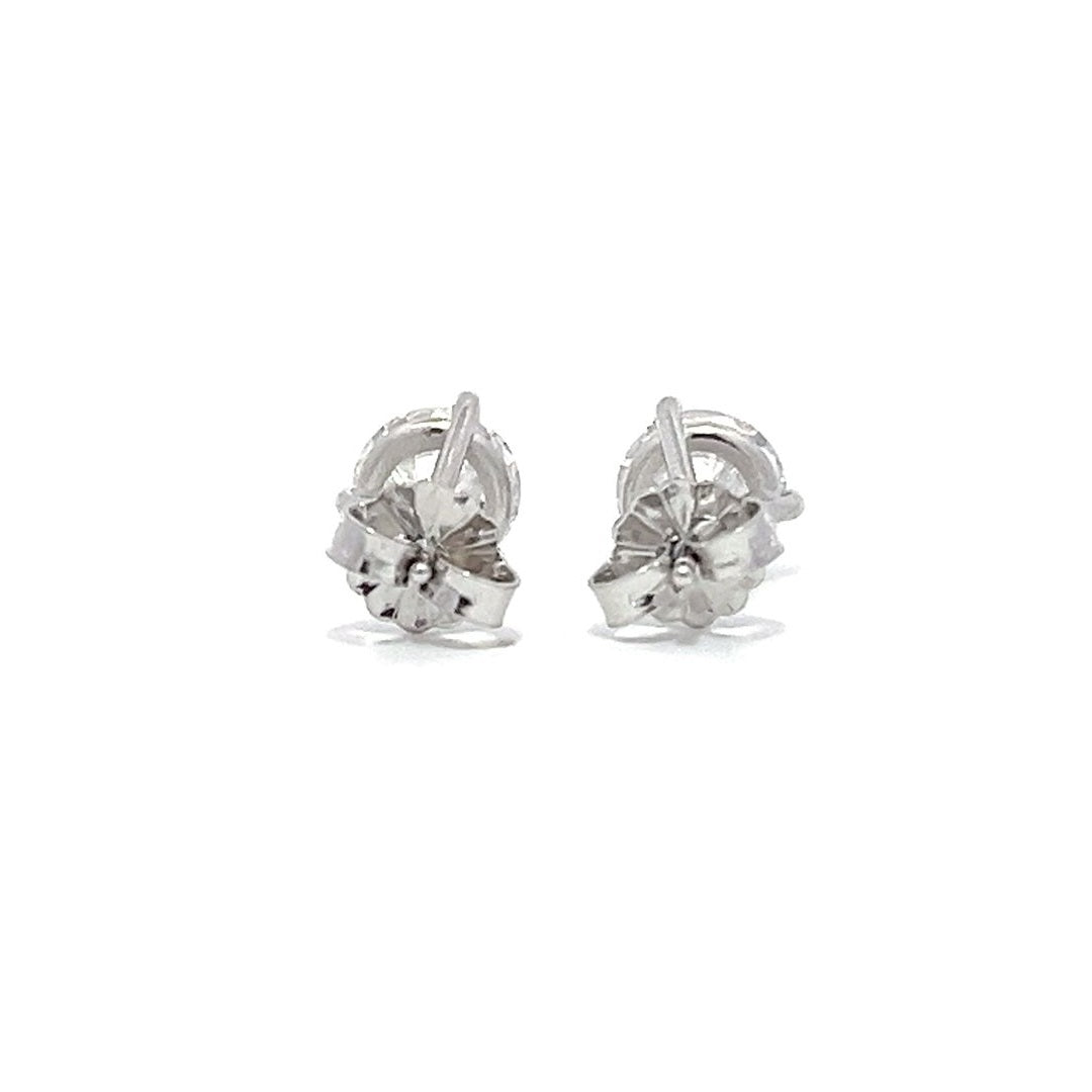 White gold stud earrings with round diamonds on a white background.