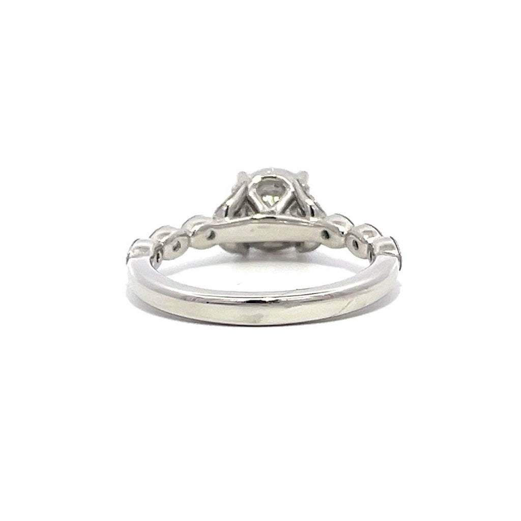 White gold diamond engagement ring with a diamond band on a white background