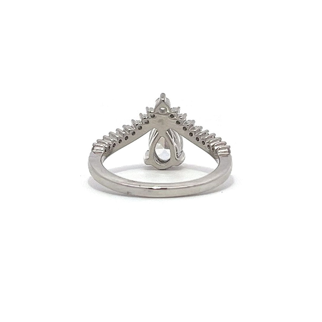 White gold pear-shaped diamond engagement ring with a diamond band on a white background