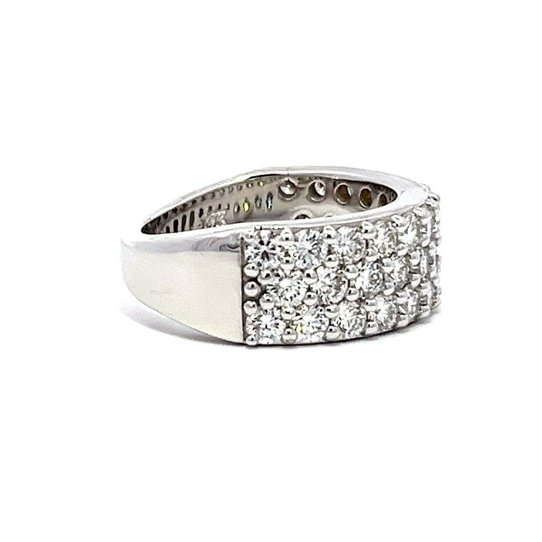 White gold eternity band with three rows of pave-set diamonds on a white background.